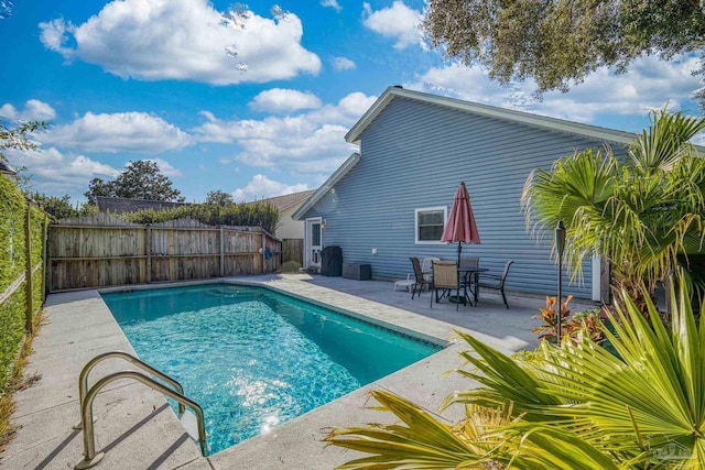 view of swimming pool featuring central AC unit and a patio