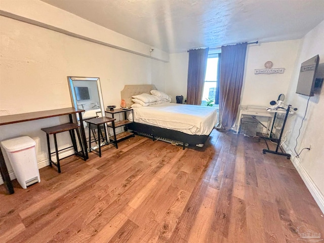 bedroom with wood-type flooring