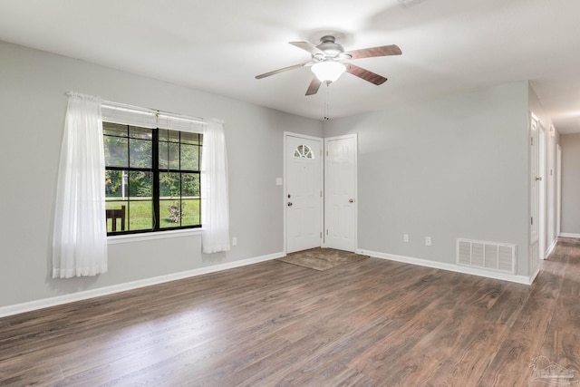 unfurnished room with dark hardwood / wood-style flooring and ceiling fan