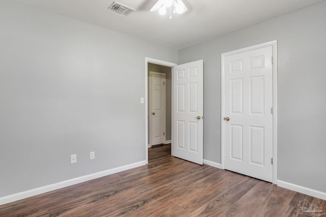 unfurnished bedroom featuring dark hardwood / wood-style flooring