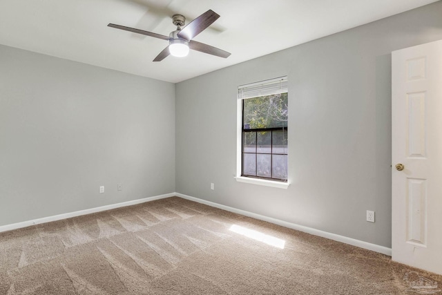 carpeted empty room featuring ceiling fan