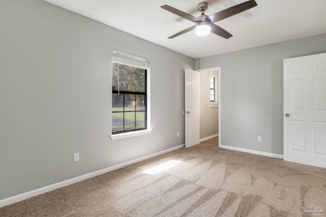 unfurnished room featuring ceiling fan and carpet floors