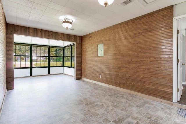 spare room with wood walls