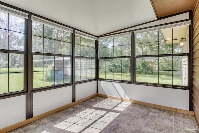 unfurnished sunroom featuring a wealth of natural light and lofted ceiling