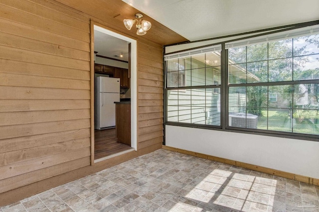 empty room featuring wooden walls