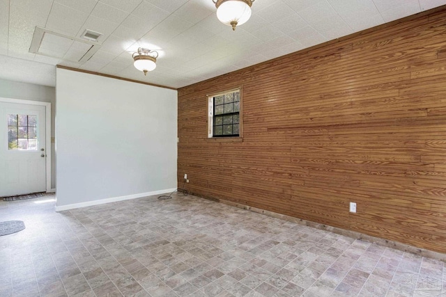 spare room featuring wood walls