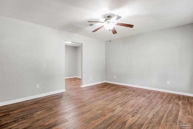 spare room with ceiling fan and dark hardwood / wood-style flooring