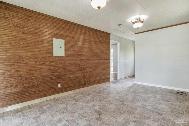 empty room featuring wooden walls and electric panel