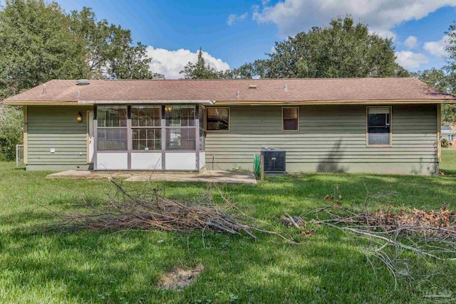 back of house with a lawn and central AC unit