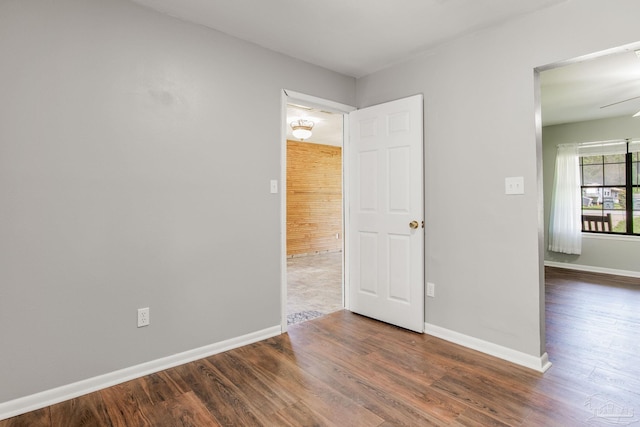 empty room featuring ceiling fan and dark hardwood / wood-style flooring