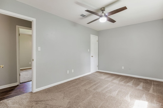 carpeted spare room with ceiling fan