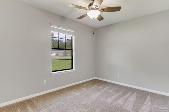 carpeted empty room featuring ceiling fan