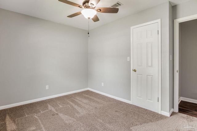 empty room featuring carpet and ceiling fan