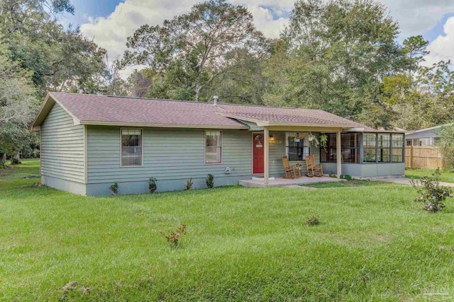 view of front of home featuring a front yard and a sunroom