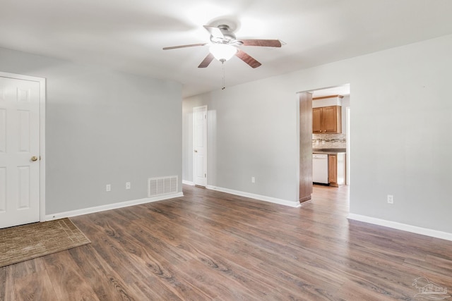 spare room with ceiling fan and dark hardwood / wood-style flooring