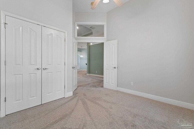 7008 Turnberry Cir, Navarre, FL 32566 - unfurnished bedroom with a closet, carpet flooring, a ceiling fan, and baseboards