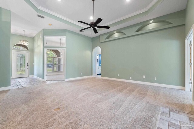 7008 Turnberry Cir, Navarre, FL 32566 - carpeted spare room with a raised ceiling, crown molding, arched walkways, and baseboards