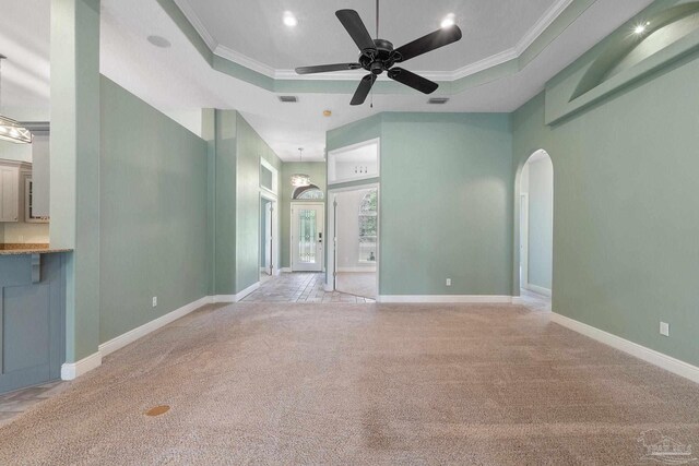 7008 Turnberry Cir, Navarre, FL 32566 - empty room with crown molding, arched walkways, ceiling fan, and light carpet