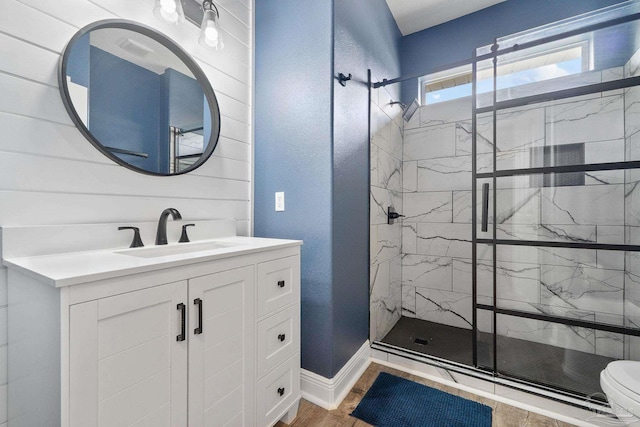 7008 Turnberry Cir, Navarre, FL 32566 - bathroom featuring vanity, toilet, a stall shower, baseboards, and wood finished floors