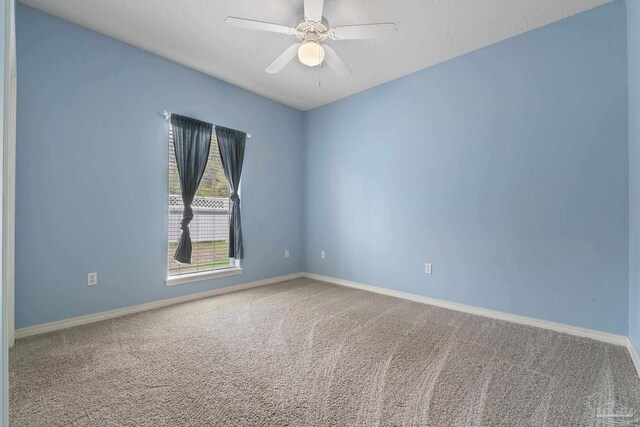 7008 Turnberry Cir, Navarre, FL 32566 - empty room featuring baseboards, a ceiling fan, and carpet flooring