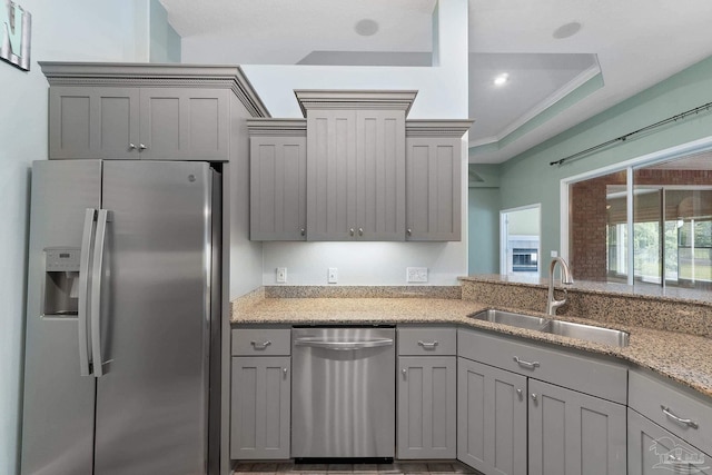 7008 Turnberry Cir, Navarre, FL 32566 - kitchen featuring gray cabinets, light stone countertops, appliances with stainless steel finishes, and a sink