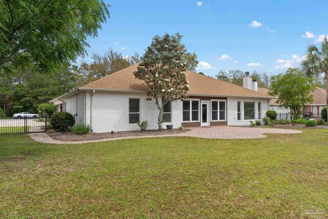7008 Turnberry Cir, Navarre, FL 32566 - rear view of property with a yard, a chimney, a patio area, and fence