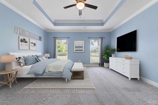 7008 Turnberry Cir, Navarre, FL 32566 - carpeted bedroom with baseboards, ornamental molding, ceiling fan, and a tray ceiling