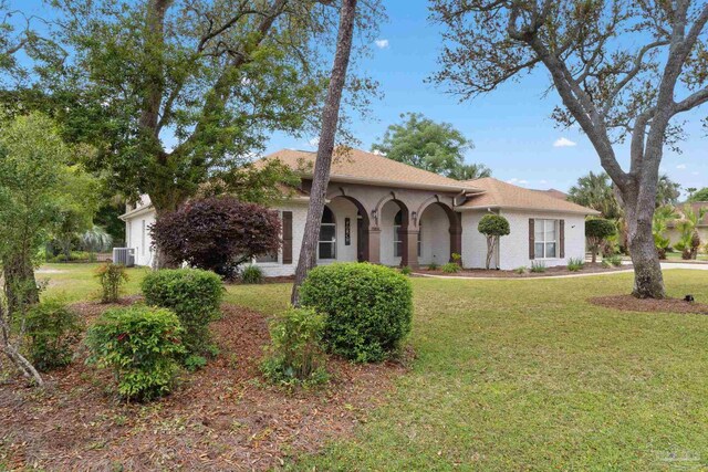 7008 Turnberry Cir, Navarre, FL 32566 - view of front of home with central AC unit and a front lawn