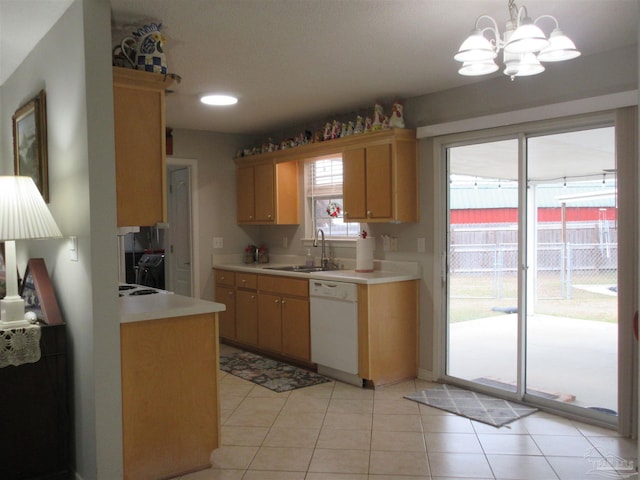 kitchen with light tile patterned floors, white dishwasher, an inviting chandelier, and sink