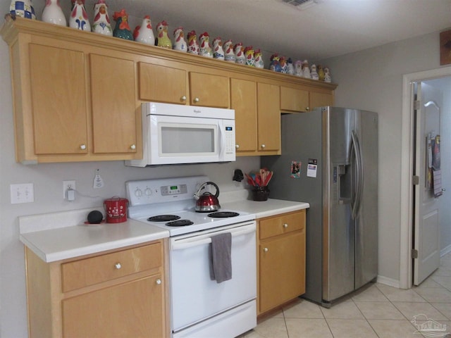 kitchen with white appliances, light brown cabinetry, and light tile patterned floors