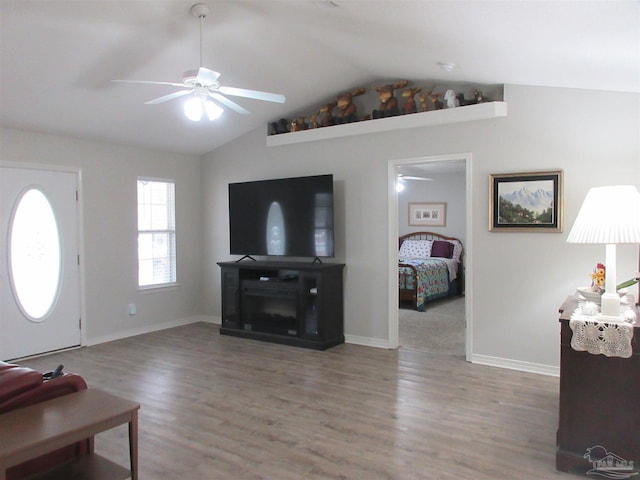 living room featuring hardwood / wood-style flooring, ceiling fan, and lofted ceiling