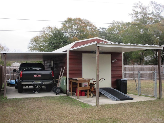 view of outdoor structure featuring a lawn and a carport