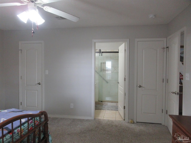 carpeted bedroom with ceiling fan and ensuite bath