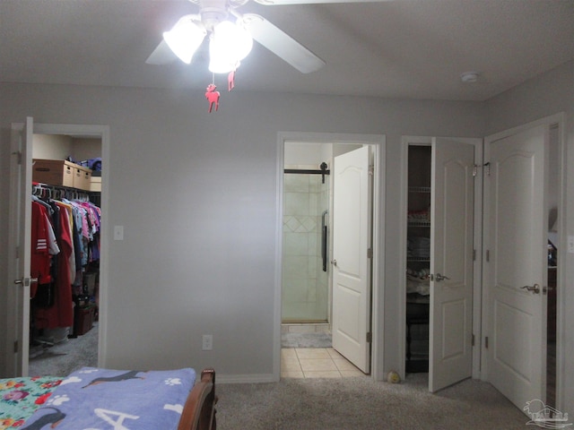 bedroom with connected bathroom, ceiling fan, and light colored carpet