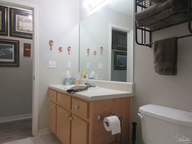 bathroom featuring vanity and toilet