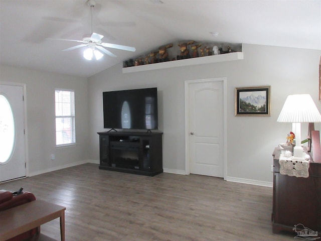 living room featuring ceiling fan, dark hardwood / wood-style flooring, and lofted ceiling