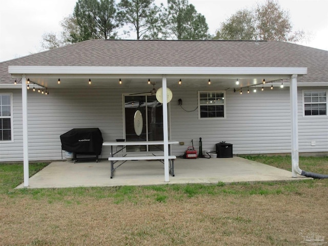 rear view of house featuring a yard and a patio