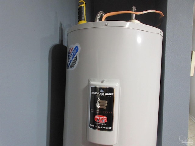 utility room featuring water heater