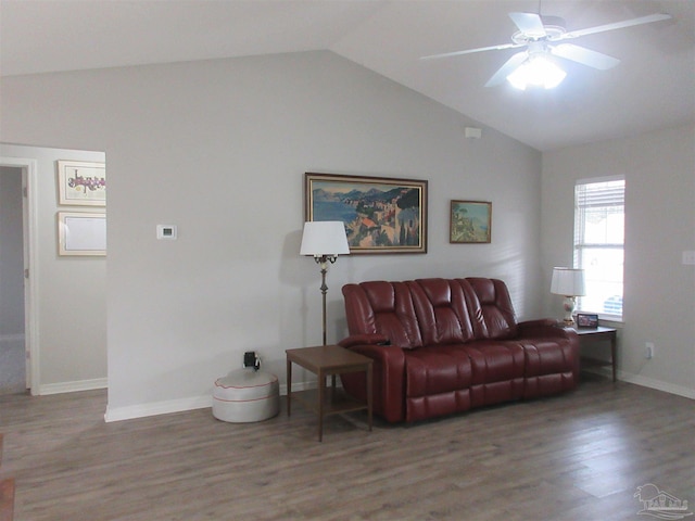 living room with ceiling fan, vaulted ceiling, and hardwood / wood-style flooring