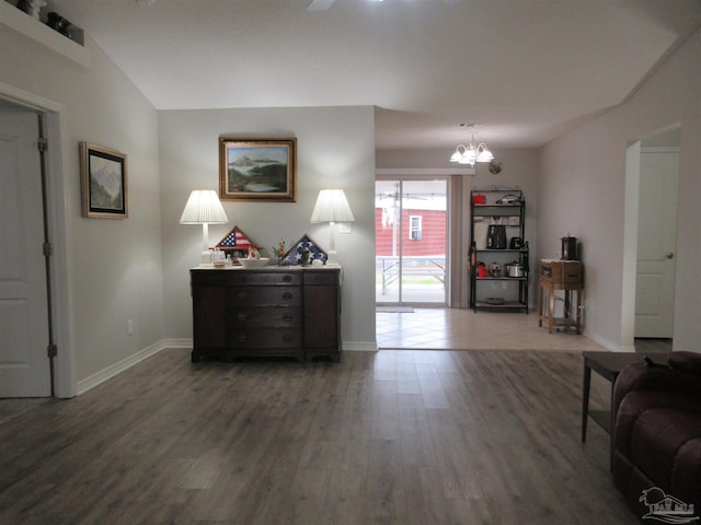 interior space featuring a notable chandelier and dark wood-type flooring