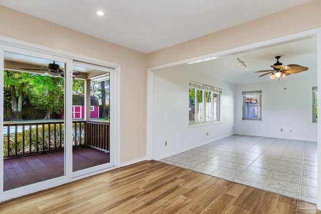 unfurnished room featuring ceiling fan and light hardwood / wood-style flooring