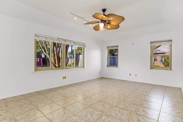 unfurnished room featuring rail lighting, plenty of natural light, and ceiling fan