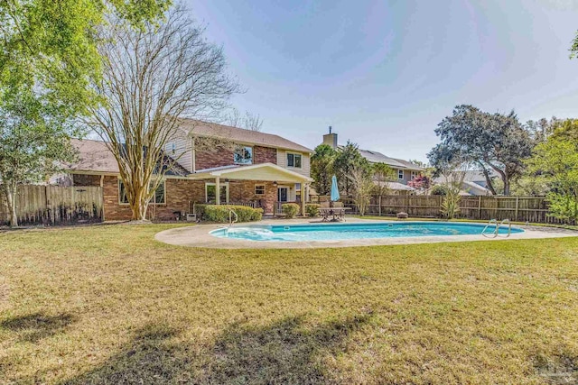 view of swimming pool with a yard