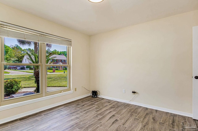 unfurnished room featuring hardwood / wood-style flooring