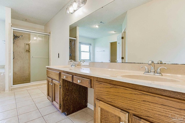 bathroom featuring tile patterned flooring, walk in shower, and vanity