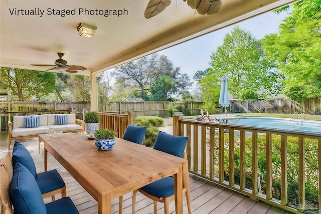 deck featuring a fenced in pool, an outdoor hangout area, and ceiling fan