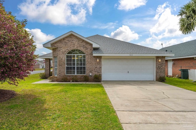 ranch-style home with brick siding, an attached garage, driveway, and a front lawn