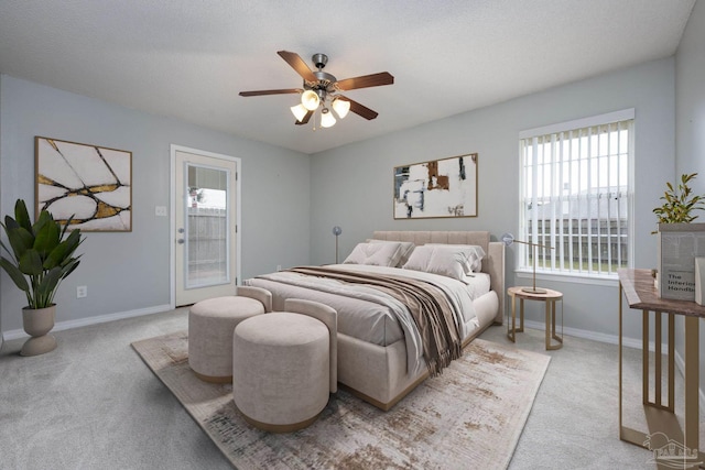 bedroom with light colored carpet, ceiling fan, and baseboards