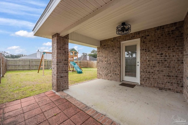 view of patio / terrace with a playground and a fenced backyard