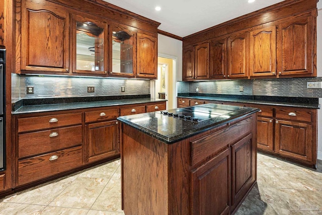 kitchen with backsplash, dark stone countertops, a kitchen island, and ornamental molding